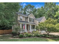 Charming two-story home with a welcoming front porch and meticulously landscaped yard at 3007 Shopton Dr, Apex, NC 27502