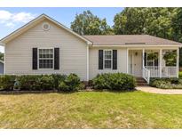 Charming single-story house with a well-manicured lawn and inviting front porch at 304 Quailwood Dr, Fuquay Varina, NC 27526