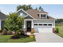 Charming one-story home featuring a manicured lawn, stone accents, and a two-car garage at 365 Middleton Pl, Chapel Hill, NC 27516