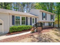 Charming two-story home featuring black shutters, landscaped bushes, and an inviting entrance at 403 Carpenter Fletcher Rd, Durham, NC 27713