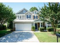 Charming two-story home with a well-maintained yard, a two-car garage, and an inviting entrance at 418 Byrams Ford Dr, Cary, NC 27513