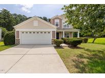 Charming home with a two-car garage, manicured landscaping, and a welcoming front porch at 4205 Twin Spires Dr, Knightdale, NC 27545