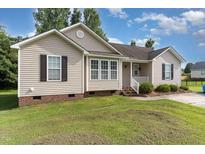Charming single-story home with a well-maintained lawn and welcoming front porch at 432 Barn View Ct, Fuquay Varina, NC 27526