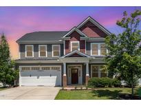 Charming two-story home boasts a manicured lawn and an inviting front entrance with a two-car garage at 4505 Wingate Song Ct, Knightdale, NC 27545