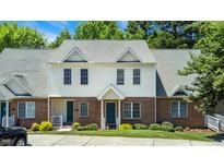 Charming townhome featuring brick and vinyl siding, well-maintained landscaping, and a welcoming entrance at 4802 Parkville Dr, Raleigh, NC 27604