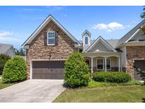 Charming home featuring a stone facade, landscaped yard, and a two-car garage at 5216 Marcella Ct, Durham, NC 27707