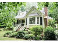 Charming two-story home featuring a well-manicured lawn and an inviting front porch at 7216 Rabbit Run, Wake Forest, NC 27587