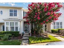 Charming townhome featuring a vibrant pink crape myrtle tree in the front yard at 7648 Winners Edge St, Raleigh, NC 27617