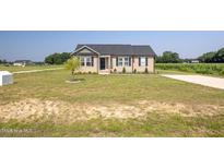 Charming single-story home with well-maintained lawn and landscaping at 82 Mamie Rd, Benson, NC 27504