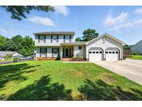 Inviting two-story home with a lush green lawn and attached two-car garage at 1 Saturn Court Ct, Durham, NC 27703