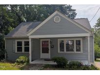 Charming single-story home with a well-maintained gray exterior and a welcoming front porch at 1102 N Guthrie Ave, Durham, NC 27703