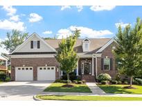 Charming brick home with a well-manicured lawn, two-car garage and inviting front entrance at 1217 Clandon Square Rd, Hillsborough, NC 27278