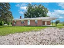 Charming brick home featuring a spacious yard and convenient carport at 1308 Tyson Loop Rd, Spring Hope, NC 27882