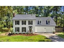 Charming two-story home with black shutters, new roof and manicured lawn at 1609 Falls Ct, Raleigh, NC 27615