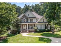 Charming two-story home with stone accents, covered porch, and beautifully landscaped front yard at 2012 Silverleaf Dr, Youngsville, NC 27596