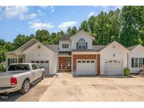 Charming two-story home featuring brick accents, multiple garage bays and inviting curb appeal at 25 Silver Pl # Apt B, Angier, NC 27501