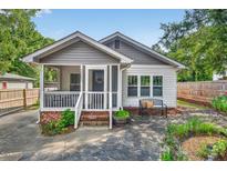 Charming home with a screened front porch, beautiful stone path and cozy seating at 2503 Shirley St, Durham, NC 27705