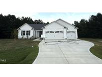 Charming single-story home with white siding, a spacious driveway, and a two-car garage at 295 Eason Creek Way, Clayton, NC 27527