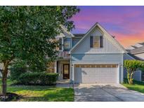 Charming two-story home with a well-manicured lawn, two car garage, and craftsman style details at 3036 Landing Falls Ln, Raleigh, NC 27616