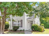 Charming townhouse with white siding, neat landscaping, and a welcoming front entrance with a brick walkway at 3147 Rapid Falls Rd, Cary, NC 27519