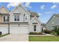 Charming two-story townhome with attached two-car garage and beautifully landscaped front yard at 3194 Retama Run, New Hill, NC 27562