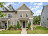 Charming two-story townhouse with a well-manicured lawn and inviting front porch at 321 Conrad Ln, Wake Forest, NC 27587