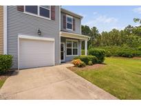 Charming two-story home featuring a one car garage, manicured lawn, and welcoming front porch at 3417 Cardinal Lake Dr, Durham, NC 27704