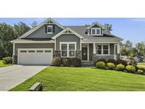 Charming two-story home featuring a well-manicured lawn and a two-car garage at 465 Gianna Dr, Clayton, NC 27527