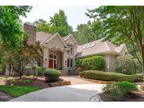 Beautiful brick home featuring a red front door and well-maintained landscaping at 4905 Ivercroft Pl, Fuquay Varina, NC 27526