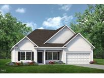 Charming single-story home with a white exterior, complemented by a well-manicured lawn and inviting curb appeal at 522 Olivia Crossing Ct # 18, Four Oaks, NC 27524