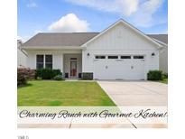 Charming one-story home with a well-manicured lawn and an attached two-car garage at 537 Bramble Ln, Clayton, NC 27527