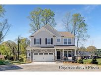 Charming two-story home featuring a stone facade, two-car garage, and a well-maintained front yard at 59 Curling Creek Dr # I285, Clayton, NC 27527