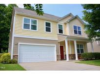 Two-story home showcasing shingle siding, a white garage door, and a cozy front porch area at 642 Collington Dr, Mebane, NC 27302