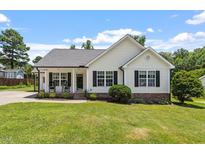 Charming single-Gathering home with a manicured lawn, covered porch, and traditional design elements at 65 Alcock Ln, Youngsville, NC 27596
