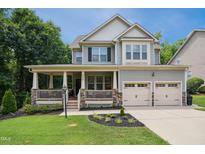 Charming two-story home with a welcoming front porch and well-manicured lawn, a perfect curb appeal at 733 Bluffcreek Dr, Fuquay Varina, NC 27526