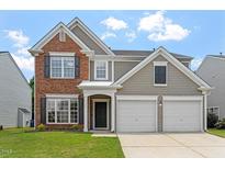 Charming two-story home featuring a combination of brick and siding facade with an attached two-car garage at 7414 Brandon Allen Ave, Raleigh, NC 27613
