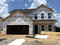 New two-story home featuring an attached two-car garage and visible construction materials at 10 Malbec Way, Youngsville, NC 27596