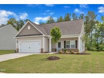 Charming single-Gathering home with a well-manicured lawn and attached two-car garage at 1012 Rhino Bnd, Oxford, NC 27565
