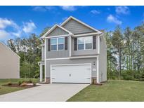 Charming two-story home with gray siding, white garage door, and well-manicured lawn at 104 Flue Ct, Oxford, NC 27565
