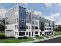 Modern townhome featuring a sleek design, multiple levels, and outdoor balconies in a residential community at 10537 Pleasant Branch Dr # 201, Raleigh, NC 27614