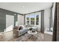 Bright living room boasts a large sectional sofa, decorative rug and an abundance of natural light at 1224 S Person St # 101, Raleigh, NC 27601