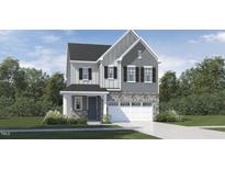 Charming two-story home with stone accents, a covered entryway, and a two-car garage at 1244 Coral Cay Bnd, Wake Forest, NC 27587