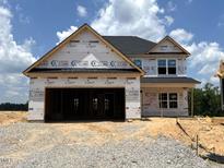 New construction two-story home with a two-car garage in the early stages of construction at 20 Malbec Way, Youngsville, NC 27596