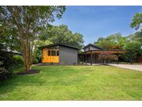 Charming mid-century home with well-maintained lawn and covered parking at 2129 Ridge Rd, Raleigh, NC 27607