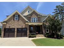 Beautiful brick home with a two-car garage, manicured lawn, and mature landscaping at 2725 Belmont View Loop, Cary, NC 27519