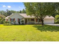 Charming single-story home with a welcoming front porch and well-maintained landscaping at 3000 Hidden Spring Ln, Oxford, NC 27565