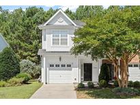 Charming two-story home with a well-manicured lawn, attached garage, and mature landscaping at 3021 Winding Waters Way, Raleigh, NC 27614