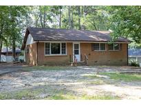 Charming brick single story house surrounded by mature trees at 3204 Friar Tuck Rd Rd, Raleigh, NC 27610