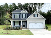 Charming two-story home with a well-maintained lawn and a two-car garage at 348 Danube Dr, Zebulon, NC 27597