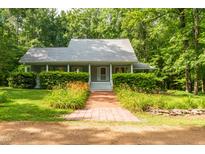 Charming home featuring a brick walkway and a well-maintained front yard with lush greenery at 3506 Arthur Minnis Rd, Hillsborough, NC 27278